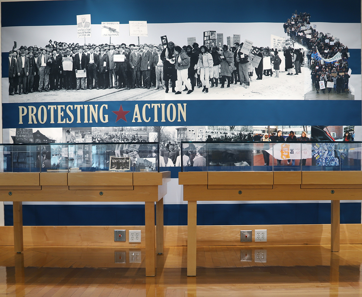 Clarke-250thExhibit-1 Photo of a wall graphic from the exhibit showing images of people protesting throughout history.