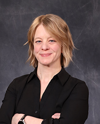 Kelly Murphy 200x250 Kelly Murphy portrait, showing head and shoulders, smiling, on a gray background