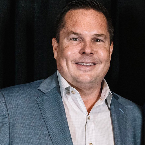 Bob_Oros_500x500 Bob Oros in a gray blazer and light dress shirt, smiling in a professional portrait