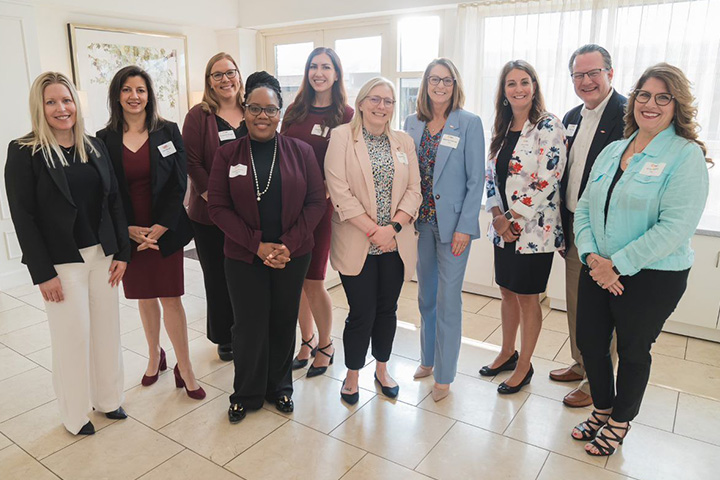 Melanie Kalmar poses with fellow attendees at a Michigan Council of Women in Technology event
