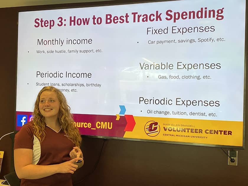 A student from the Financial Wellness Collaborative presents information about tracking spending.